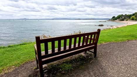 a bench facing the sea in aberdour, scotland