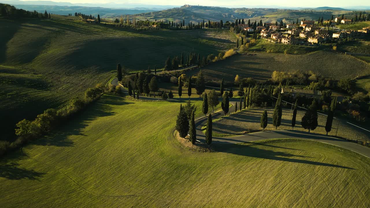 Drown descends orbitting around winding road down picturesque mountain, Val d'Orcia Tuscany