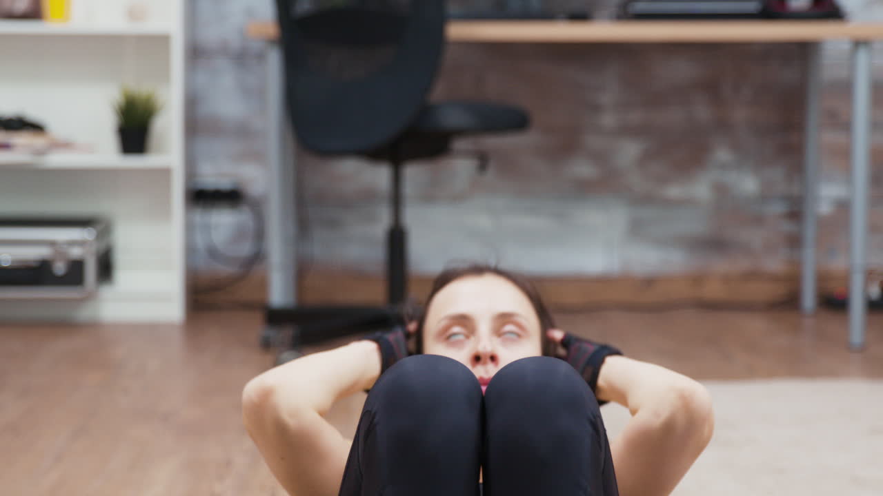Woman doing sit-ups at home