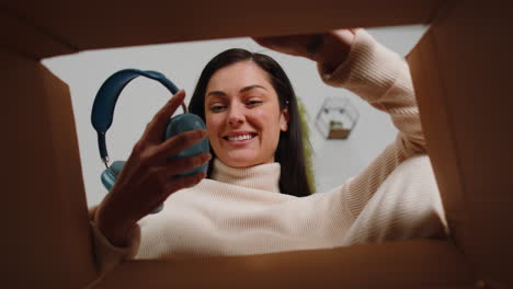 happy young woman shopper unpacking cardboard box delivery parcel online shopping purchase at home