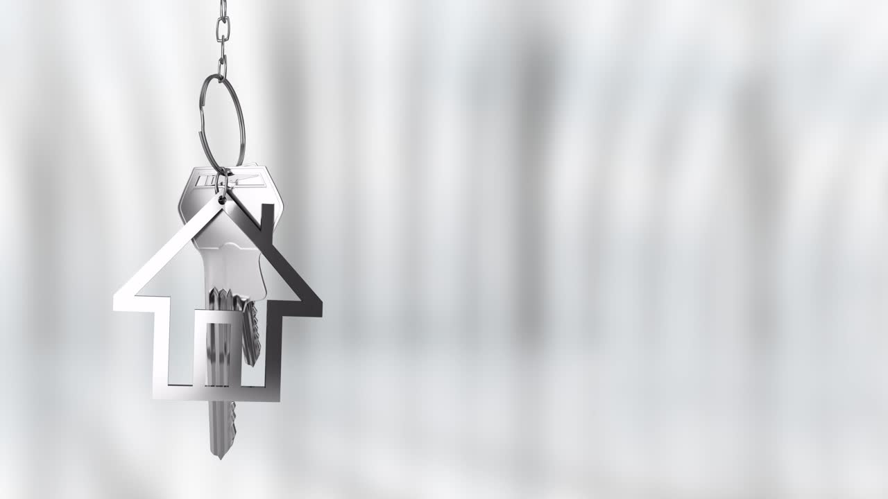 Animazione di un portachiavi a forma di casa e chiavi su sfondo sfocato.