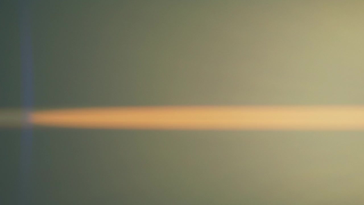 Anamorphic lens flares fading into dark background