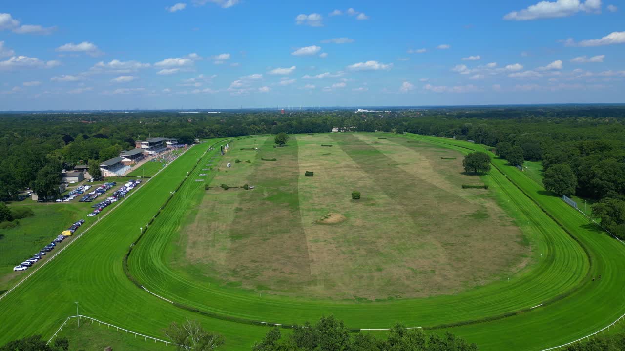 Horse gallop racecourse near a forest in Germany, parking lot visible. Lovely aerial view flight panorama overview drone