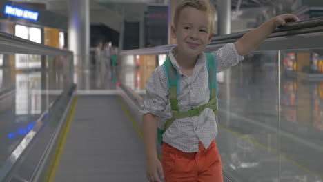 cute little boy on travelator in airport