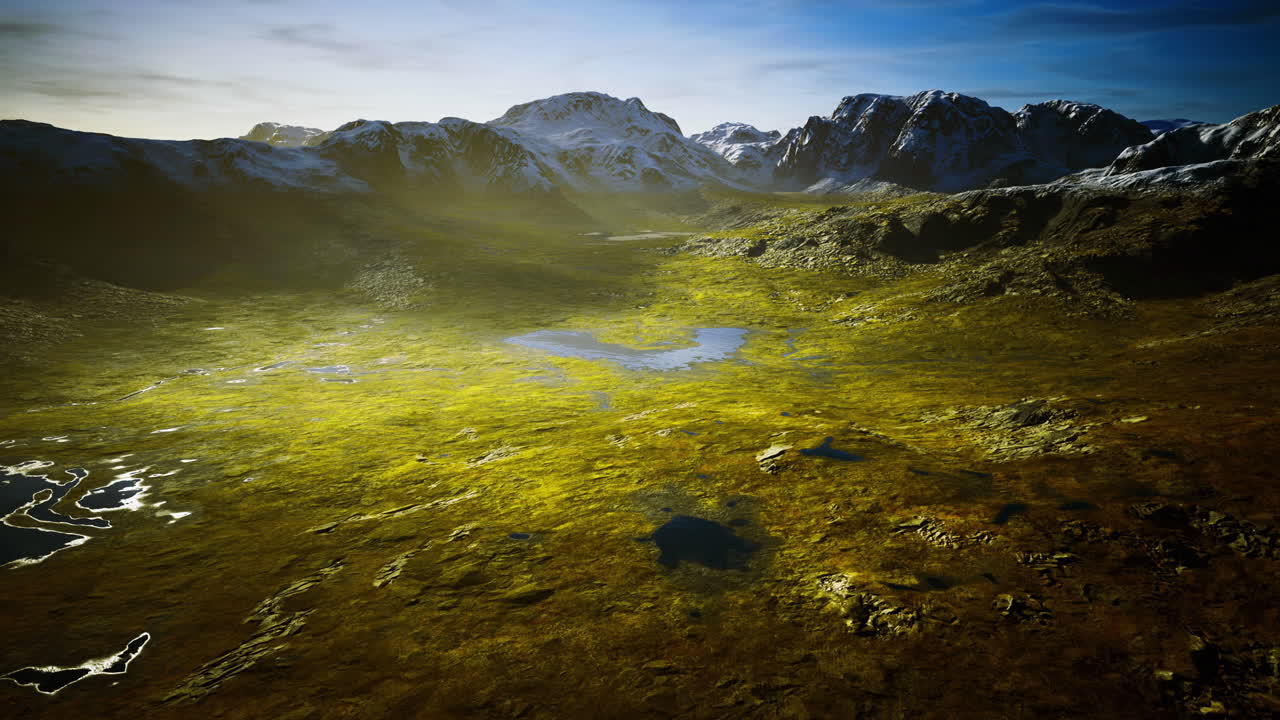 Vast landscape with mountains and lakes under a clear blue sky in daylight