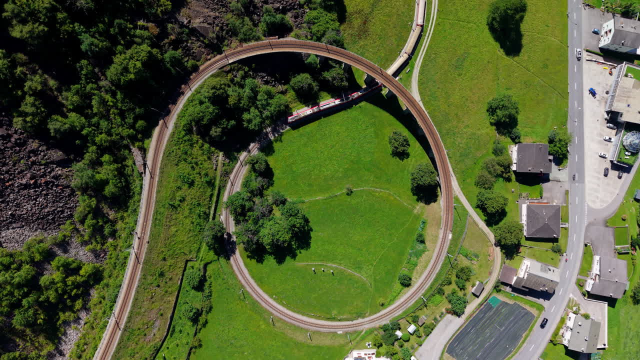 Aerial view of circular track with Bernina train, scenic Switzerland journey