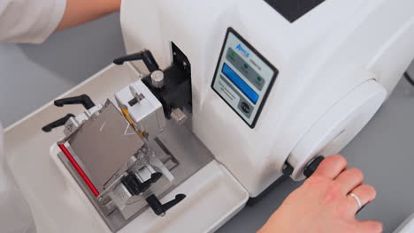 laboratory with sample from patient. nurse feeds data of test tubes for analysis