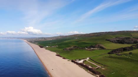 Aerial-shot-panning-over-a-beautiful-beach-on-the-coast-of-England-in-summer