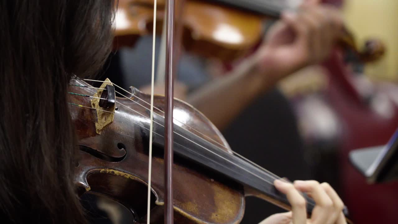 Front side view of a violinist playing violin