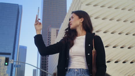 asian lady take picture high urban buildings using smartphone close up.