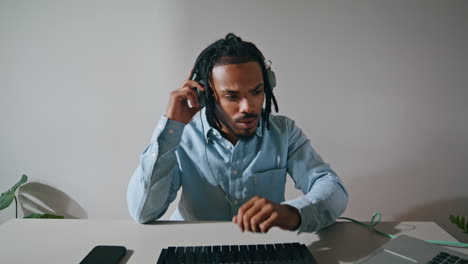 Freelance-guy-taking-headphones-on-apartment-closeup.-Arranger-started-working