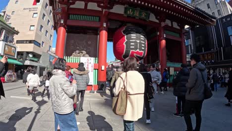 tourists and locals at a traditional temple gate