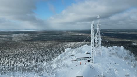 snowy mountaintop with communication tower