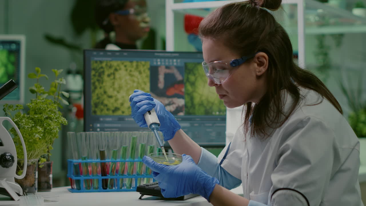 Chemist woman taking dna liquid from test tube with micropipette
