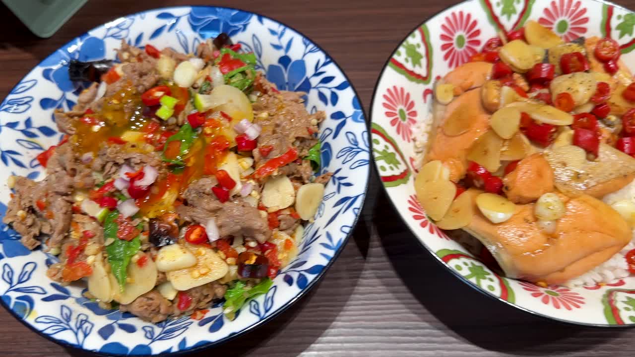 Colorful rice bowls with sliced beef, salmon, shrimp, soft-boiled eggs, and assorted vegetables are arranged on a wooden table under bright, even lighting. Overhead camera movement reveals vibrant ingredients and careful presentation