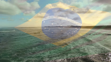 animazione della bandiera del brasile che sventola sopra le mani sulla spiaggia