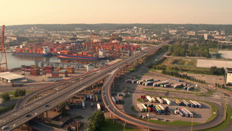 aerial view long straight highway 468 alongside awanport seaport, gdynia, poland