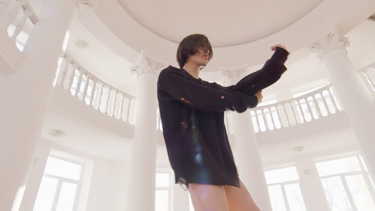 Bottom view of contemporary male japanese dancer training dance moves in the middle of the studio