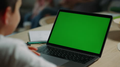 kid using chroma key laptop indoors