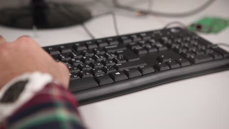 person typing on a computer keyboard