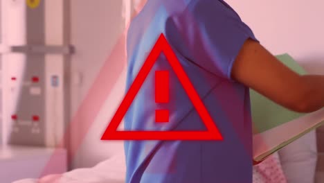 Red-triangle-warning-sign-over-doctors-taking-care-of-patients-in-a-hospital-in-background