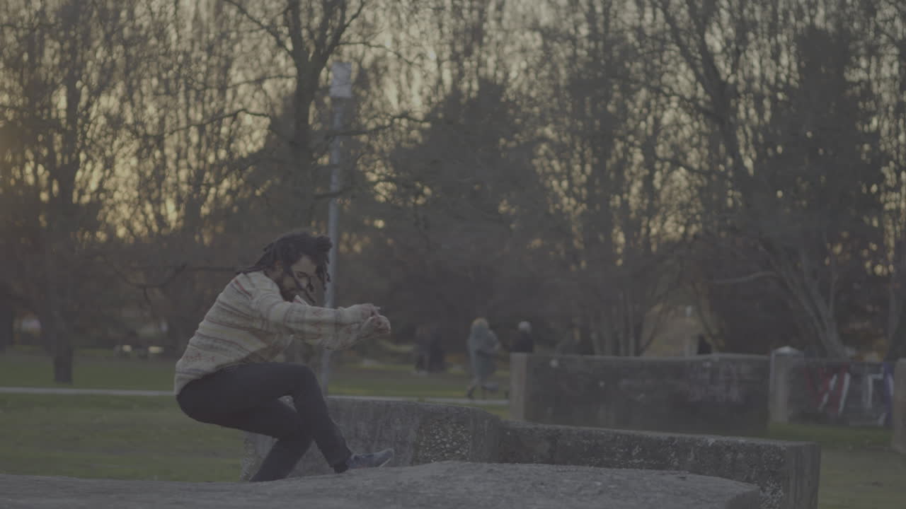Man jumping in a park at sunset