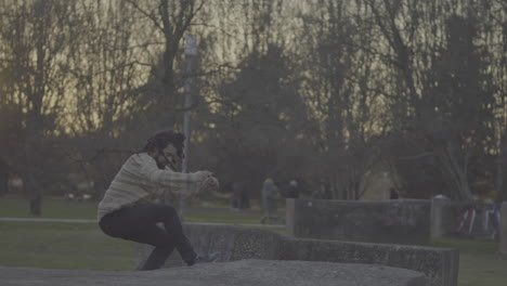man jumping in a park at sunset