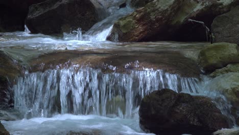 closeup of a natural stream finding its way through a rocky stream bed