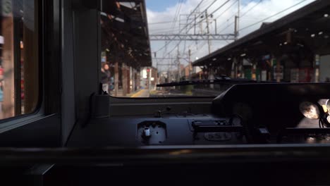 view of structures along the enoshima dentetsu railway in japan from the train's cabin - wide shot