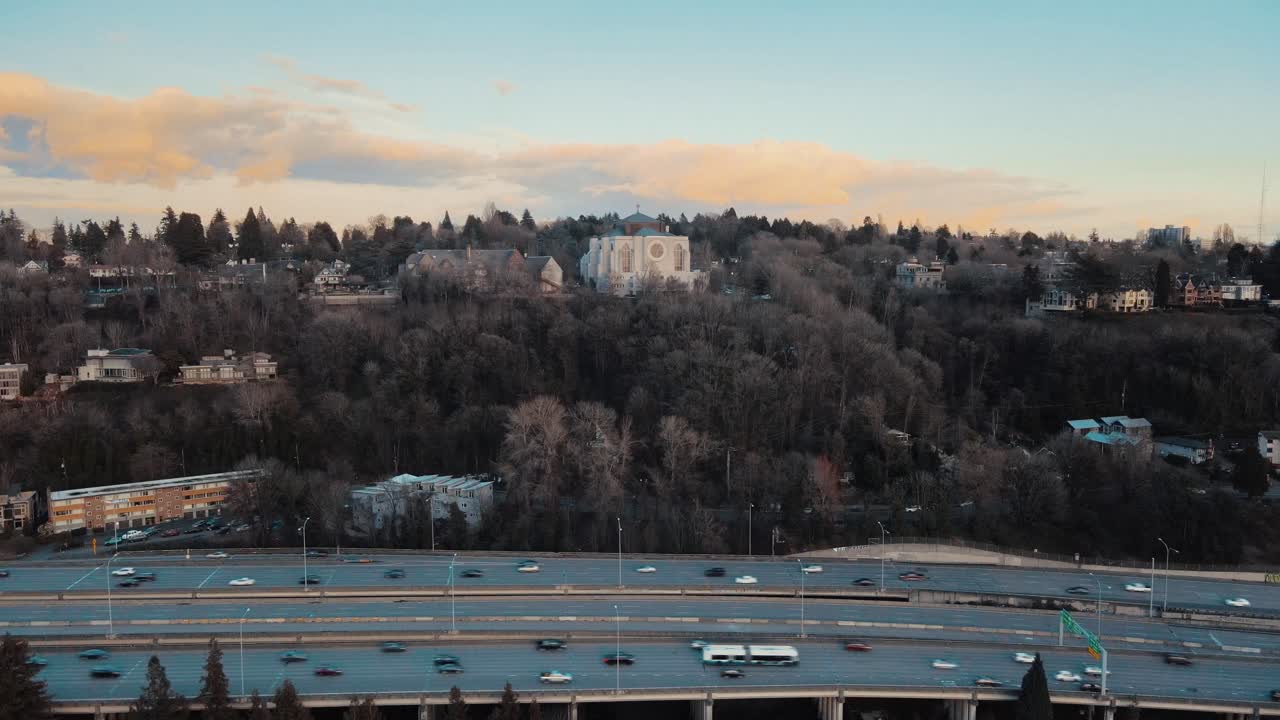 Stationary Aerial view showing St Mark's Cathedral and traffic on Freeway in Seattle City during golden hour