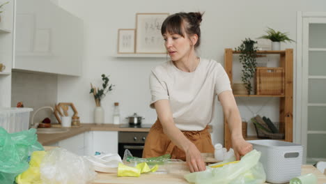 young woman sorting plastics at home