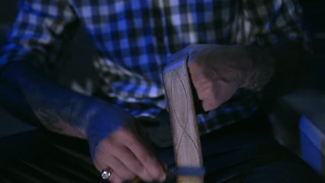 man making a leather belt