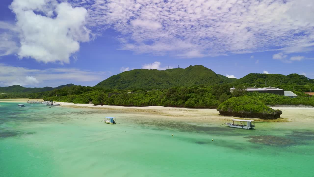 Breathtaking aerial drone shot over a pristine tropical island. Clear turquoise water flows through lush green mangroves, creating a stunning natural landscape. Ideal for travel or nature projects