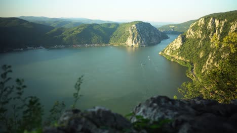 Timelapse-of-Cazanele-Dunarii-in-the-summer-at-sunset,-we-can-see-boats-in-the-distance