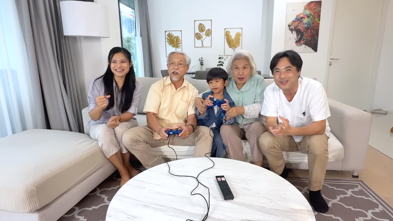 Three generations enjoy video games in a bright living room, smiling and interacting enthusiastically