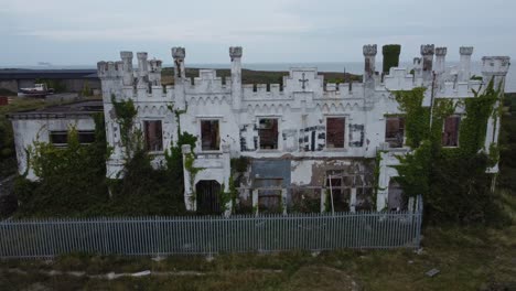 soldiers point house aerial view circling across abandoned secured holyhead victorian castle mansion