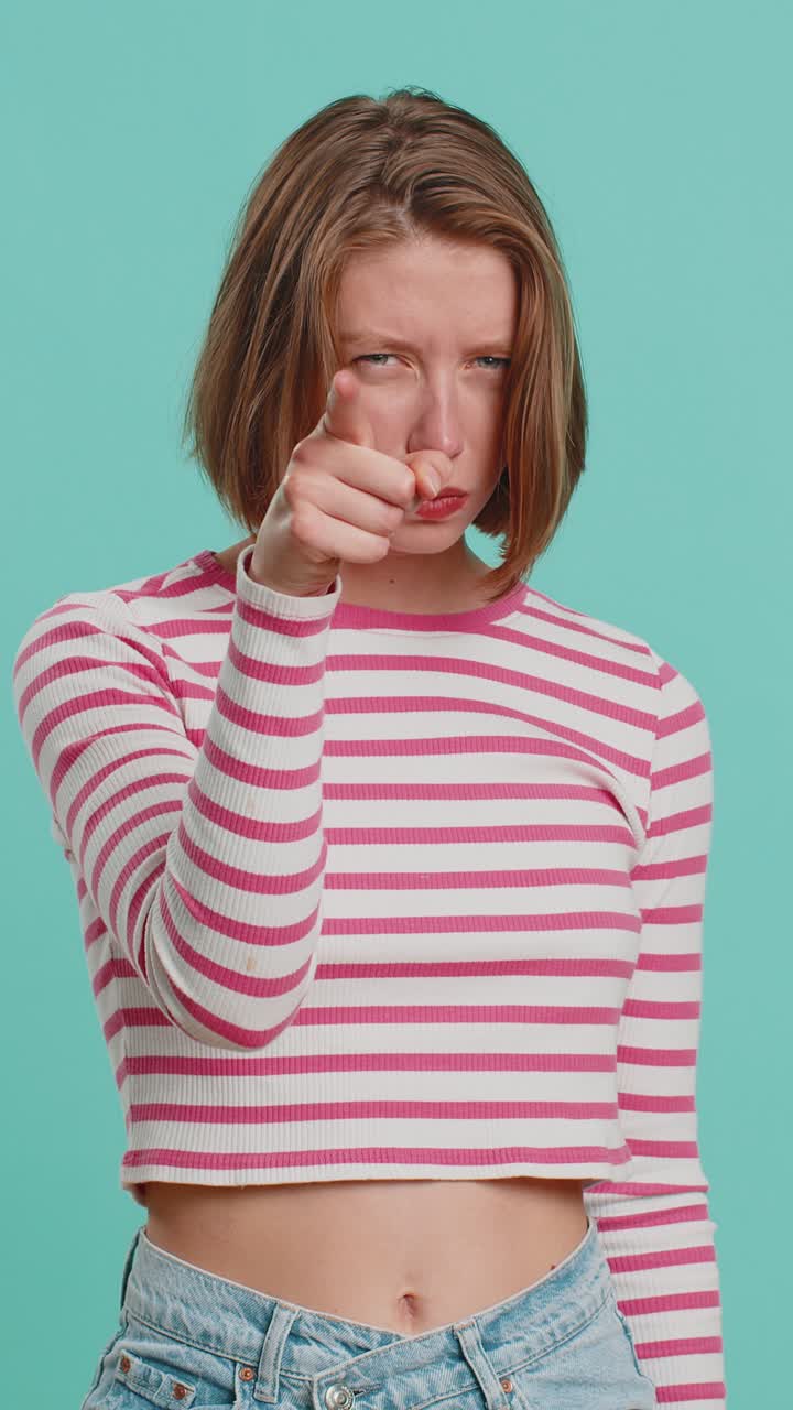 Woman pointing at her eyes and camera show i am watching you gesture spying watching on someone