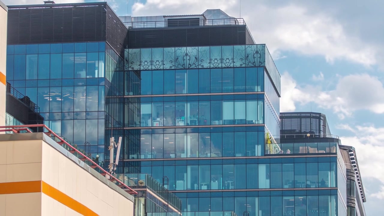 Ventanas en edificios de oficinas de cristal en Tverskaya Zastava cerca del Templo de San Nicolás en timelapse desde la azotea en Moscú, Rusia. Vista aérea superior en un día de verano con cielo nublado.