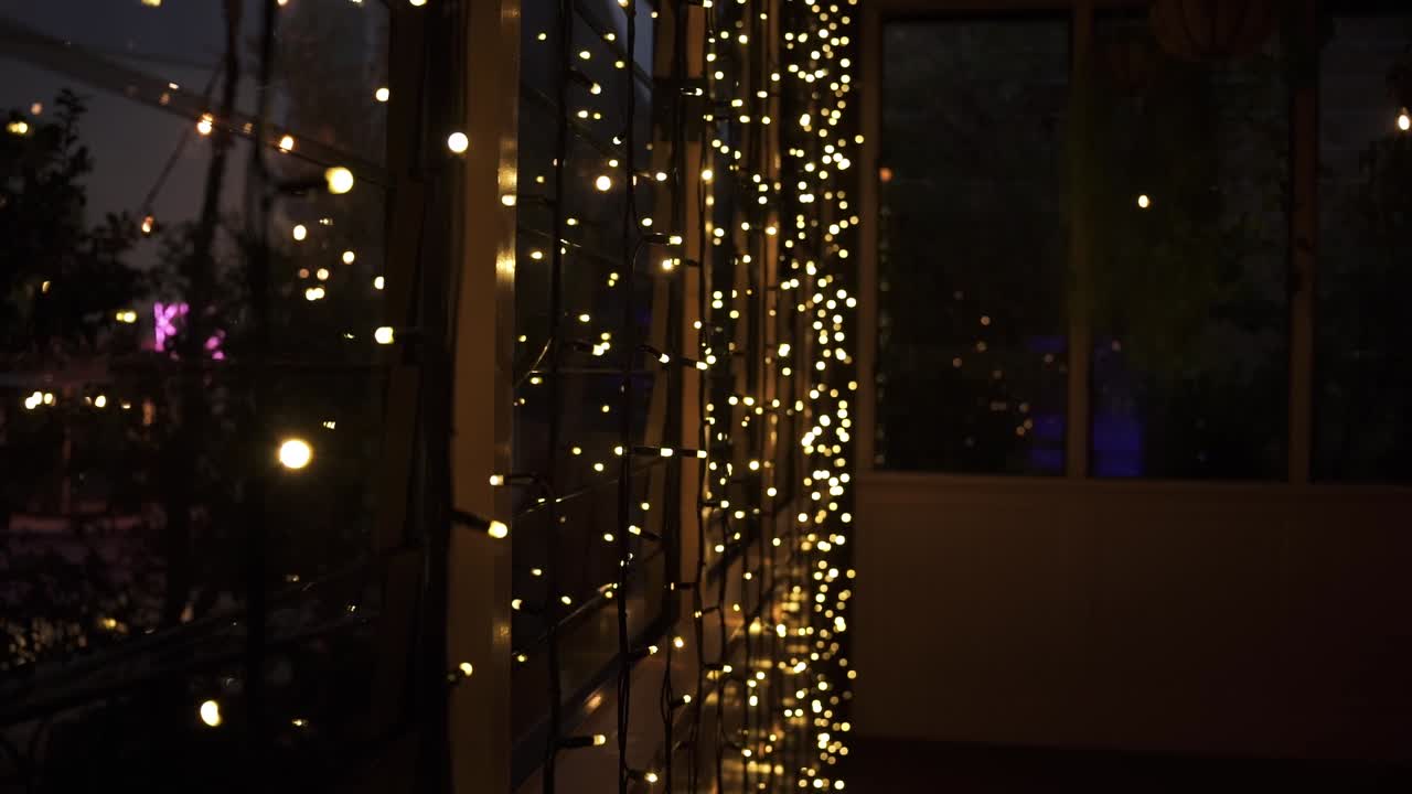 Fairy Lights Hanging In A Window At Night - close up
