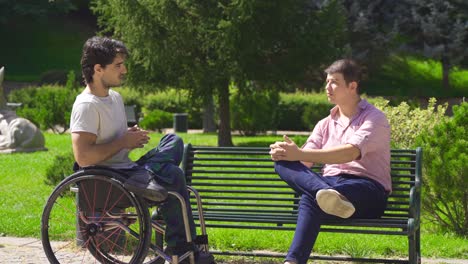 he is chatting with his physically handicapped young friend.