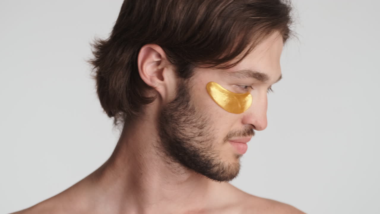 Caucasian man in front of camera on white background.