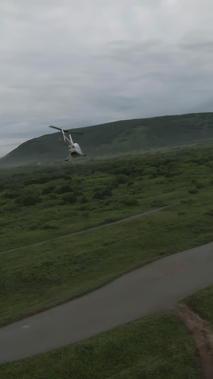Helicopter Flying Over Alaskan Landscape