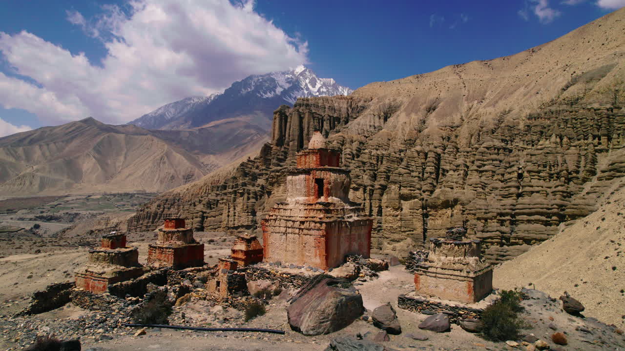 Captivating drone footage orbits a unique structured stupa near Ghami road, Upper Mustang, Nepal. Alluring backdrop of artistic mountains and hills. Discover the beauty of Annapurna Area