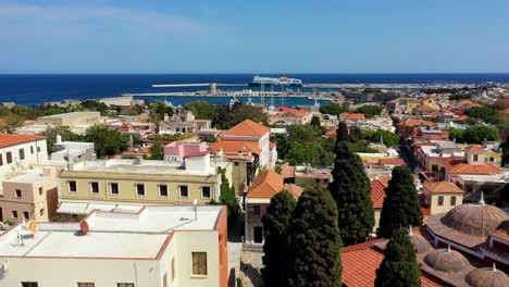 the suleyman mosque in the old town of rhodes, rhodes island, greece. medieval clock tower (roloi clock tower) in the city of rhodes in rhodes island in greece.