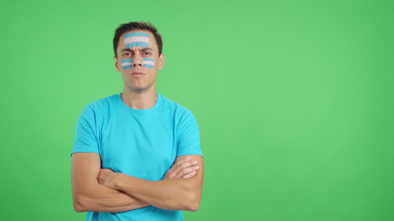 Dignified and serious man with argentine flag painted on face