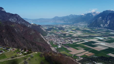 Drone-fly-above-the-Vionnaz-and-Torgon-and-revealing-the-lake-Léman,-Montreux-and-Vevey,-in-Switzerland