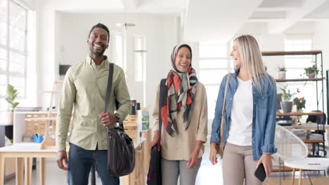 portrait of happy diverse business people walking in office in slow motion