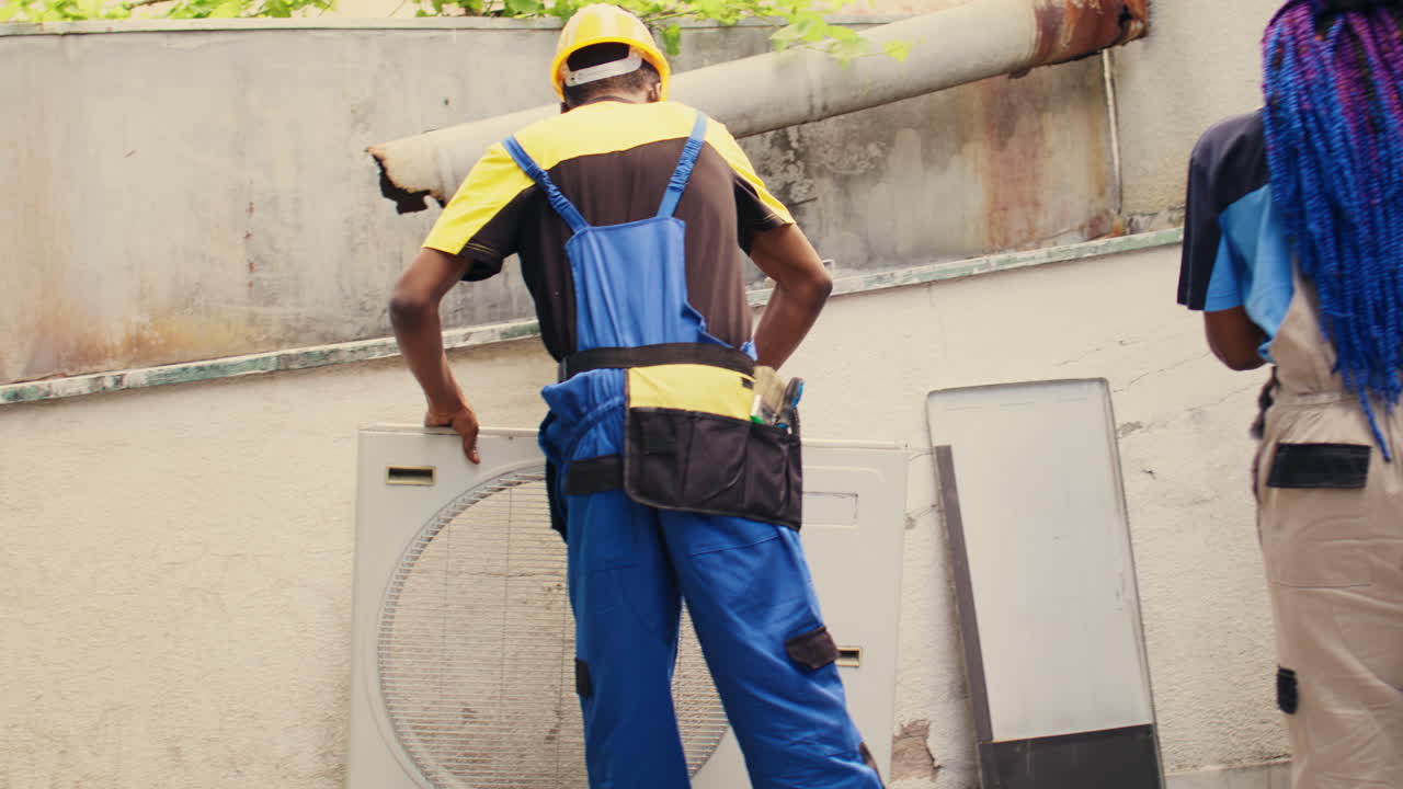 Technicians working on air conditioner