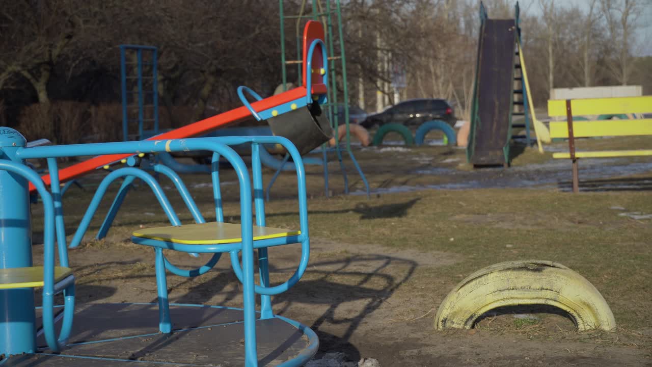 Empty Swing is Spinning on the Playground in the Yard