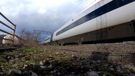 footage of trains approaching stoke on trent train station in the midlands by the canal, waterside and a50 motorway